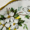 Close-up of dogwood decoration and gold trim on Royal Albert White Dogwood saucer
