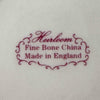 Backstamp on base reading "Heirloom Fine Bone China, Made in England" in burgundy script with decorative cartouche