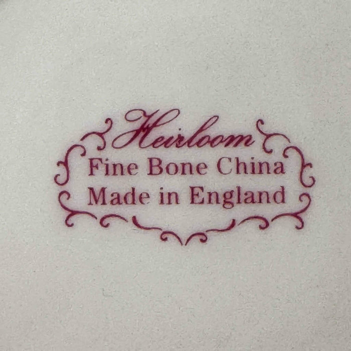 Backstamp on base reading "Heirloom Fine Bone China, Made in England" in burgundy script with decorative cartouche