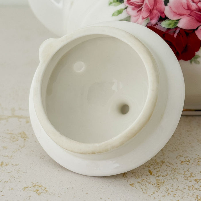 Close-up of underside of lid on pink and burgundy rose Heirloom teapot