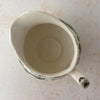 Top down view of Johnson Bros Friendly Village creamer showing opening and interior