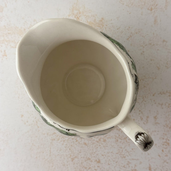 Top down view of Johnson Bros Friendly Village creamer showing opening and interior