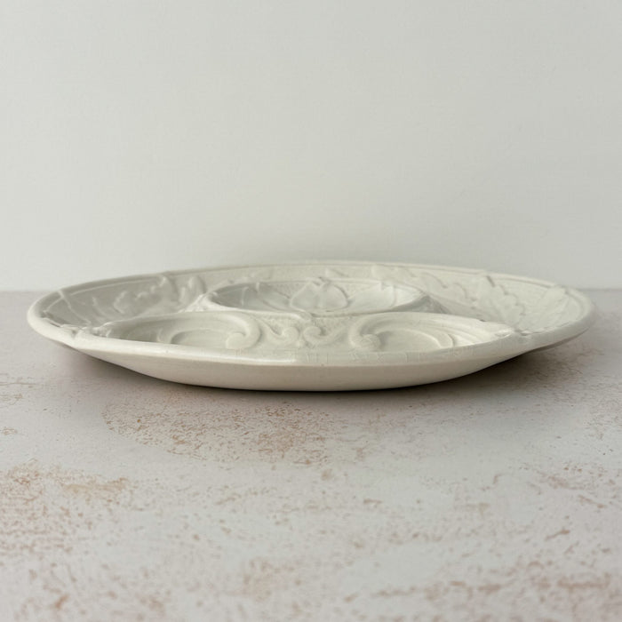 Side view of Gien White Majolica artichoke plate