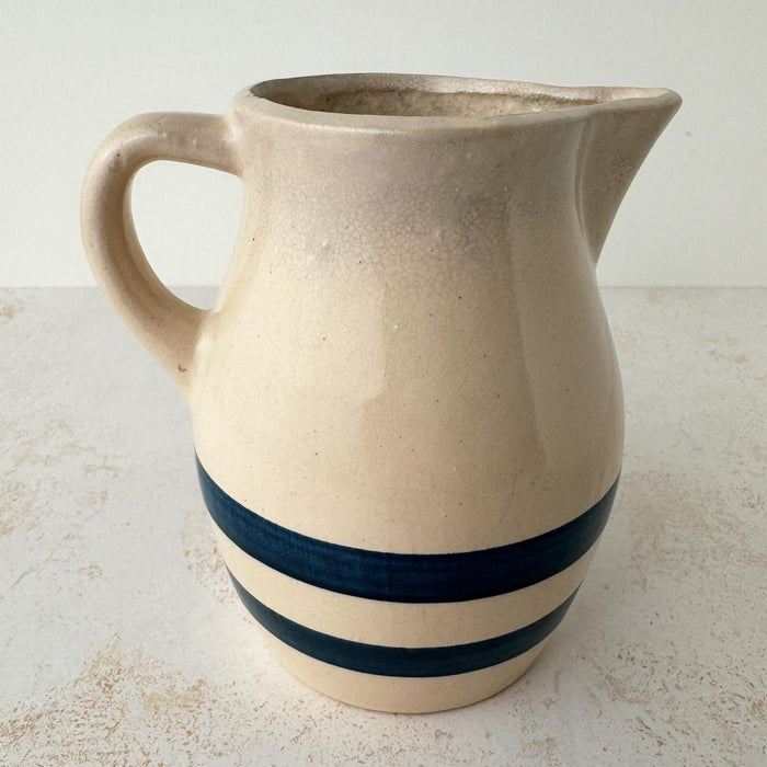 Opposite side view of vintage stoneware pitcher with cobalt blue bands