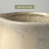 Close-up of the crazing and staining around the opening of the vintage stoneware pitcher and a label reading "stained crazing"