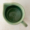 Top down view showing opening and interior of green Monmouth ribbed stoneware creamer