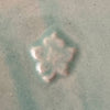 Close-up of maker's mark on green Monmouth ribbed stoneware creamer