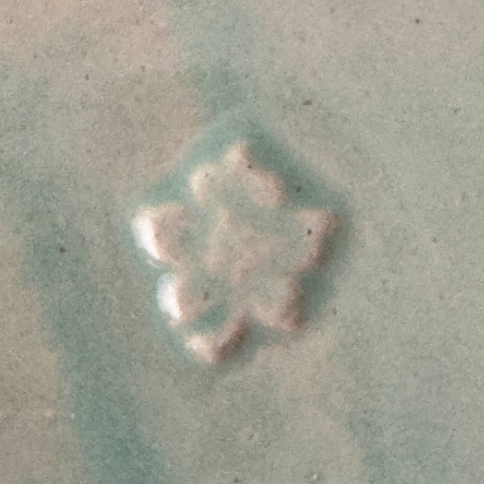 Close-up of maker's mark on green Monmouth ribbed stoneware creamer