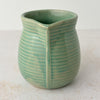 Spout side of green Monmouth ribbed stoneware creamer