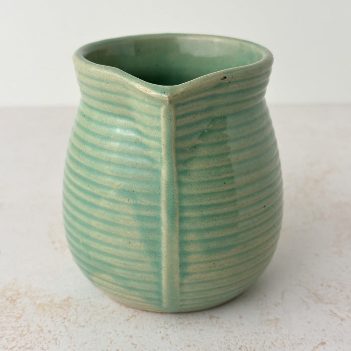 Spout side of green Monmouth ribbed stoneware creamer