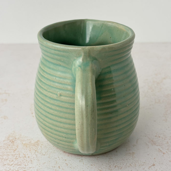 Handle side of green Monmouth ribbed stoneware creamer