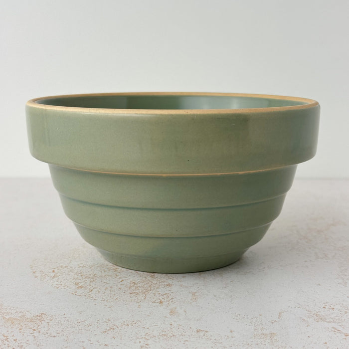 Side view of green Over and Back yellowware bowl showing stepped design