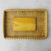 Underside of lid of vintage lidded bamboo picnic basket with handles raised