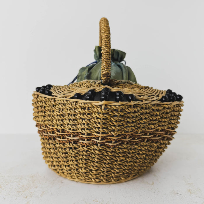 End view of antique wicker vanity basket with beaded hexagonal form