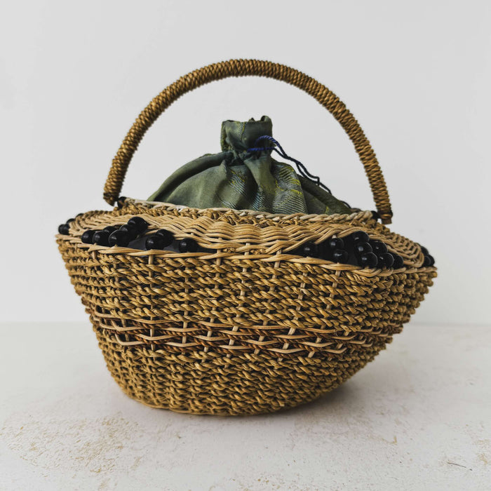 Back view of antique wicker vanity basket with beaded hexagonal form