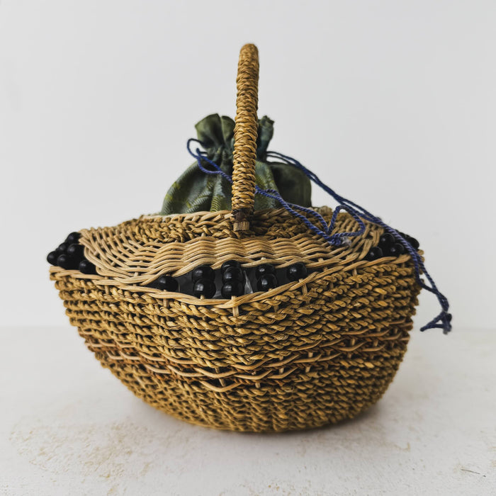 Opposite end view of antique wicker vanity basket with beaded hexagonal form