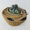 Three-quarter view of antique wicker vanity basket with beaded hexagonal form