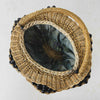 Top down view showing opening and fabric closure draped inside antique wicker vanity basket with beaded hexagonal form