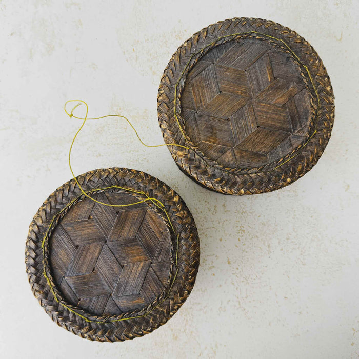Top down view of bottom and top of vintage woven bamboo rice basket
