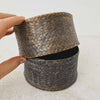 Hand lifting lid of vintage woven bamboo rice basket