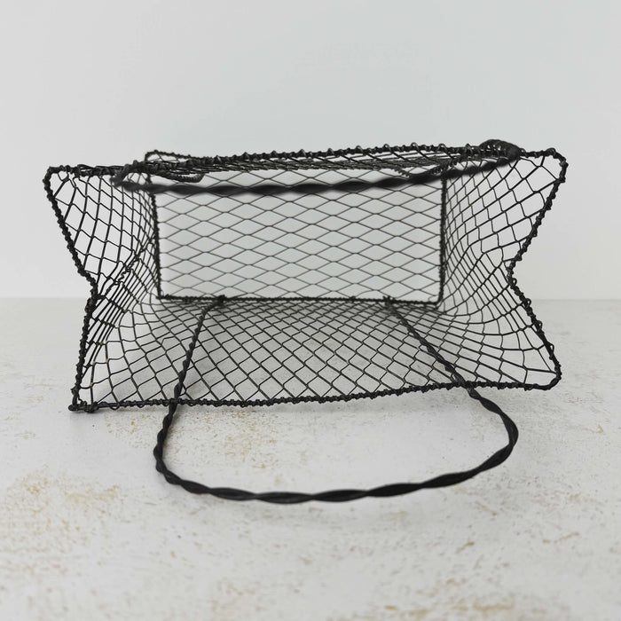 Top down view showing inside of vintage handwired wire basket with twisted handles