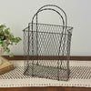 Vintage handwired wire basket with twisted handles and aged patina, styled empty on a crochet runner with antique book and trailing plant