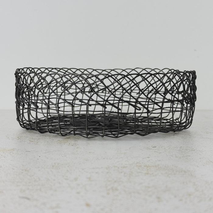Side view of vintage handwired shallow round wire basket