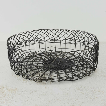 Three-quarter view of vintage handwired shallow round wire basket