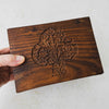 Hand holding vintage tree of life wooden box