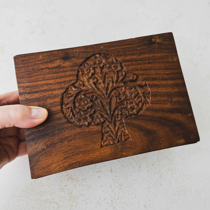 Hand holding vintage tree of life wooden box