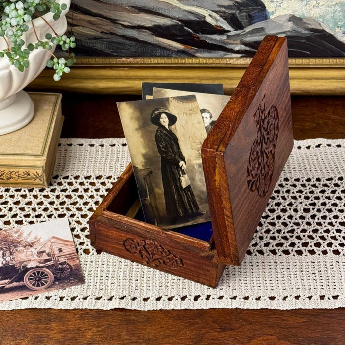 Hand carved Tree of Life wood box displayed open with vintage photographs showing carved details and keepsake storage