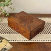 Vintage carved wood box with tree of life design and floral side carving, styled on a crochet runner with trailing plant and old photographs