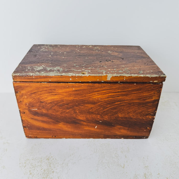 Angled view of antique primitive storage box with faux grain paint finish