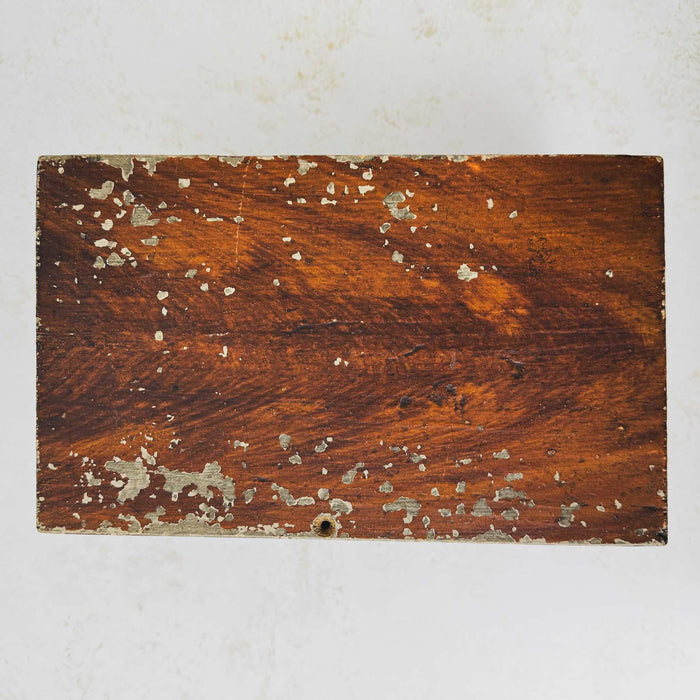 Top down view of antique primitive storage box with faux grain paint finish