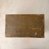 Antique wooden storage box underside with worn surface, scratches, edge wear, and visible square nail heads around the bottom