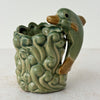 Front side of vintage majolica style dolphin planter
