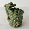 Back side of vintage majolica style dolphin cachepot