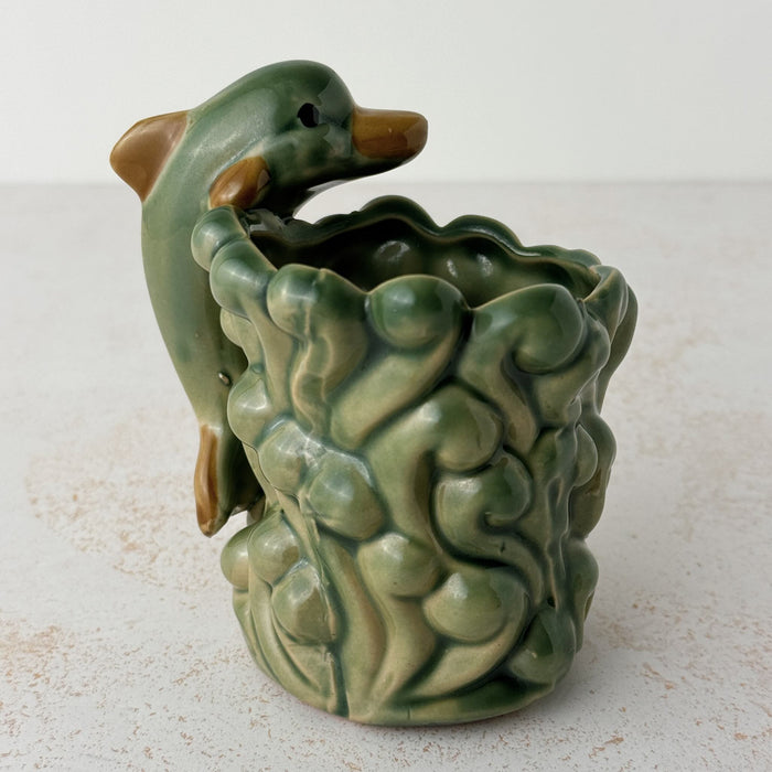Back side of vintage majolica style dolphin cachepot