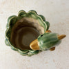 Top down view showing opening and interior of vintage majolica style dolphin cachepot