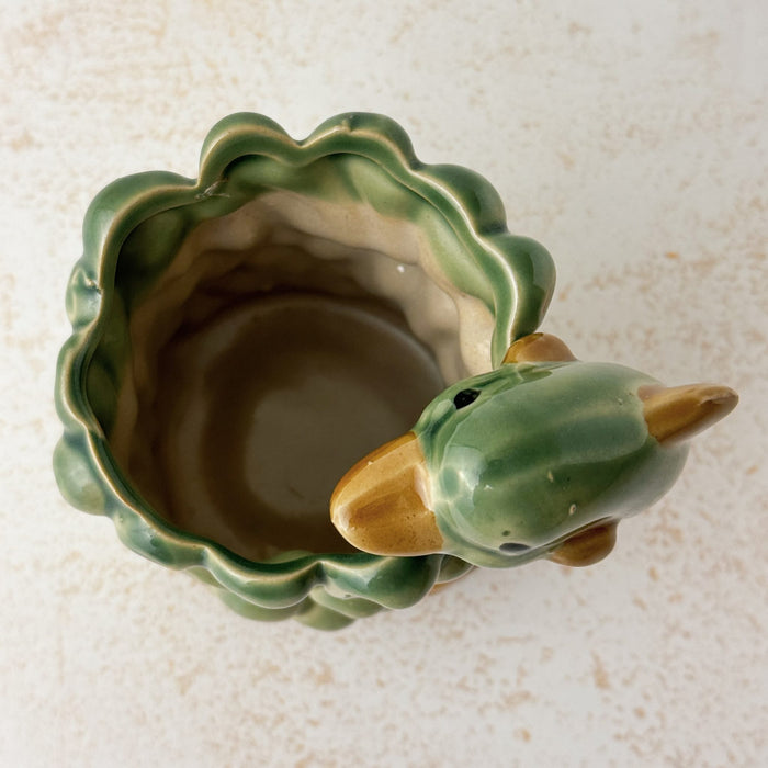 Top down view showing opening and interior of vintage majolica style dolphin cachepot