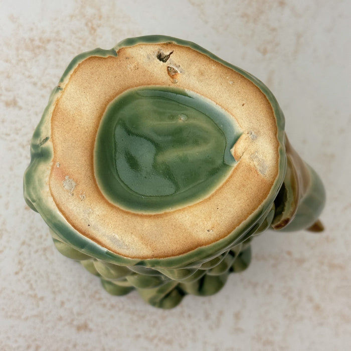 Bottom of vintage majolica style dolphin cachepot