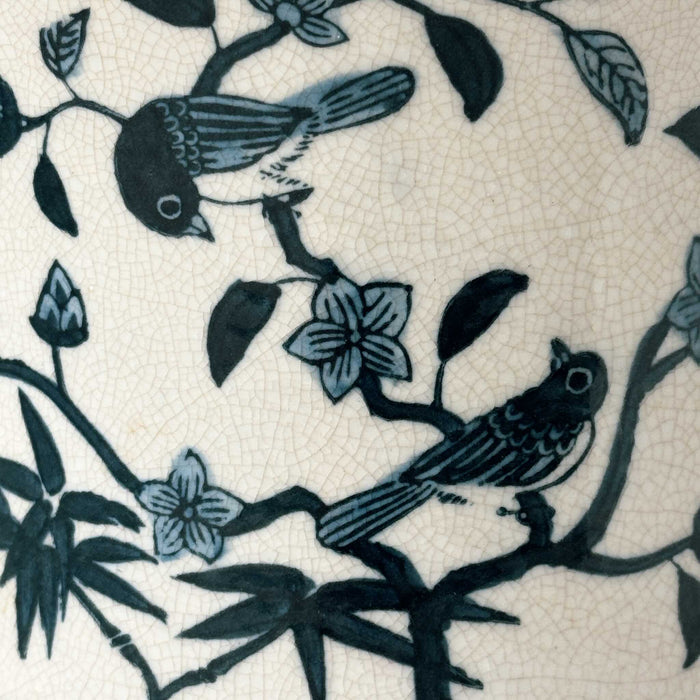 Close-up of birds and flowers on Asian-style blue and gray ceramic cachepot