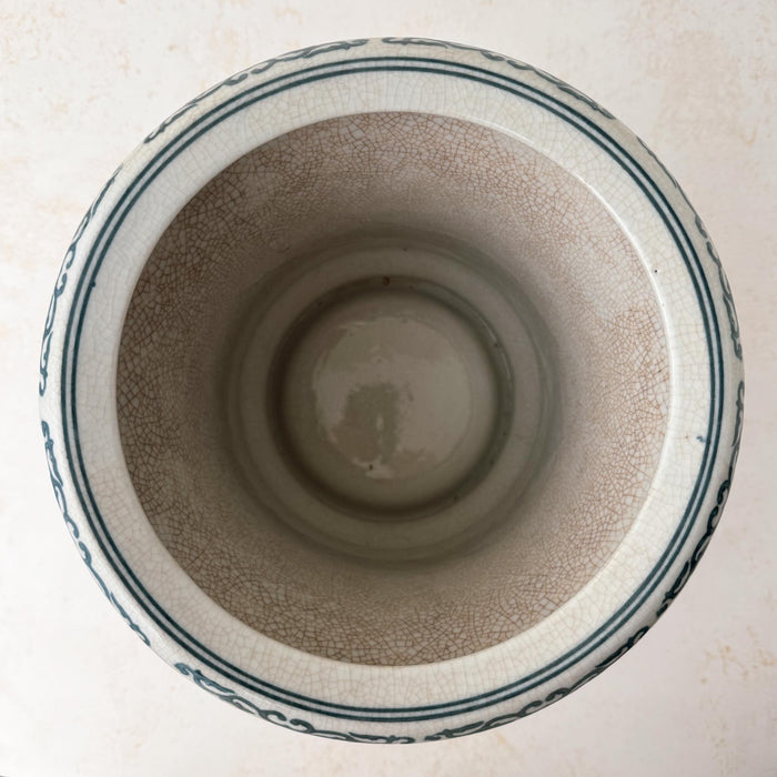 Top down view showing opening and interior of Asian-style blue and gray ceramic cachepot