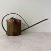 Back side view of vintage brass indoor watering can with copper accents