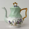 Front view of Jean Pouyat Limoges violets teapot