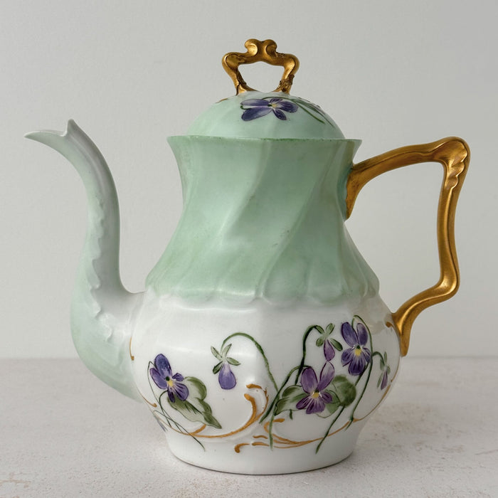 Front view of Jean Pouyat Limoges violets teapot