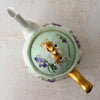Top down view of Jean Pouyat Limoges violets teapot with lid on