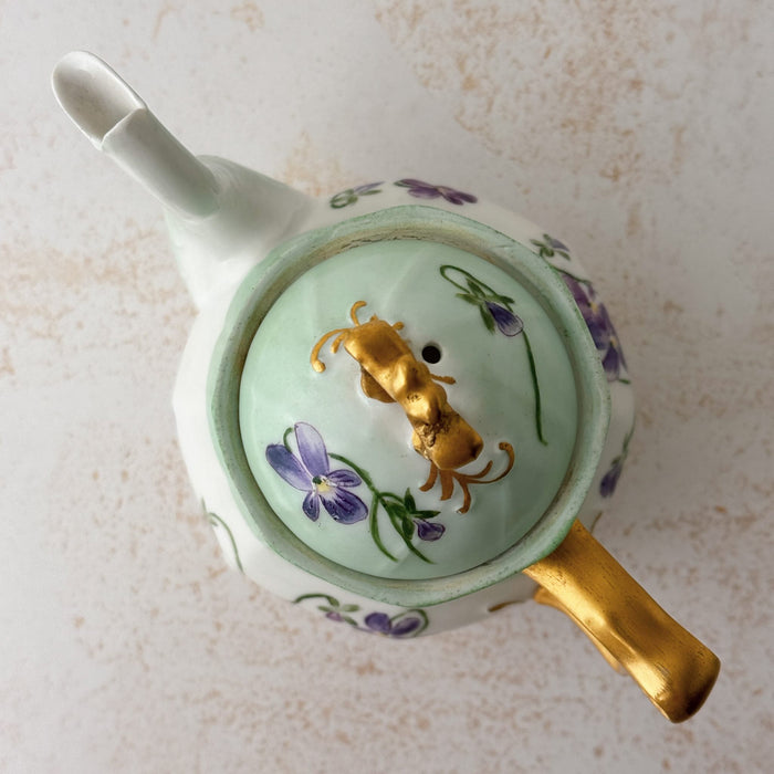 Top down view of Jean Pouyat Limoges violets teapot with lid on