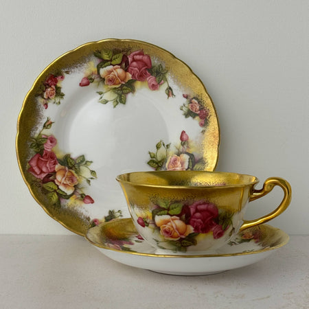 Royal Chelsea Golden Roses side plate standing behind matching teacup and saucer