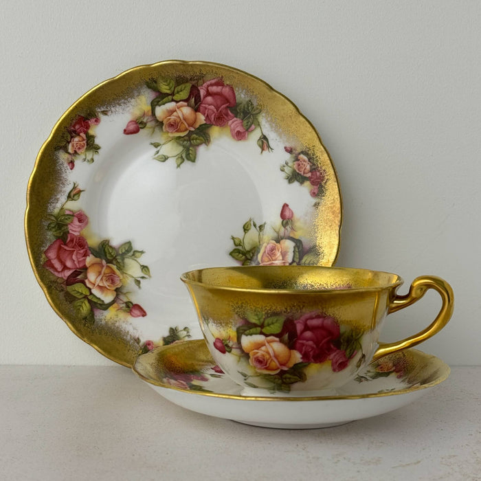 Royal Chelsea Golden Roses side plate standing behind matching teacup and saucer
